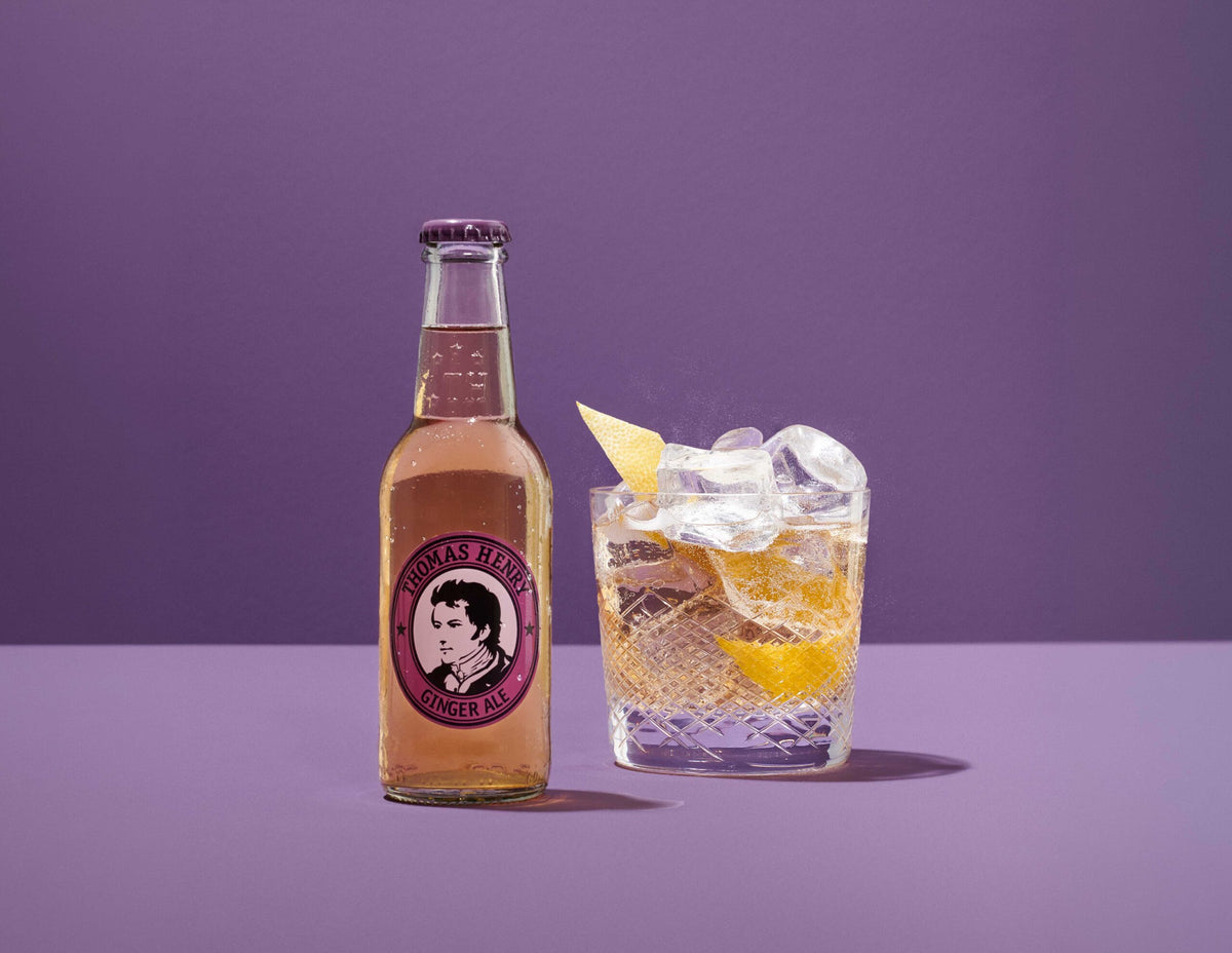 Thomas Henry Ginger Ale 200ML bottle beside a highball serve